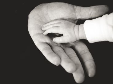 Holding baby hand